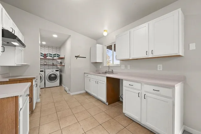 a kitchen with cabinets and appliances