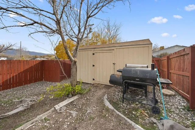 a backyard of a house with table and chairs