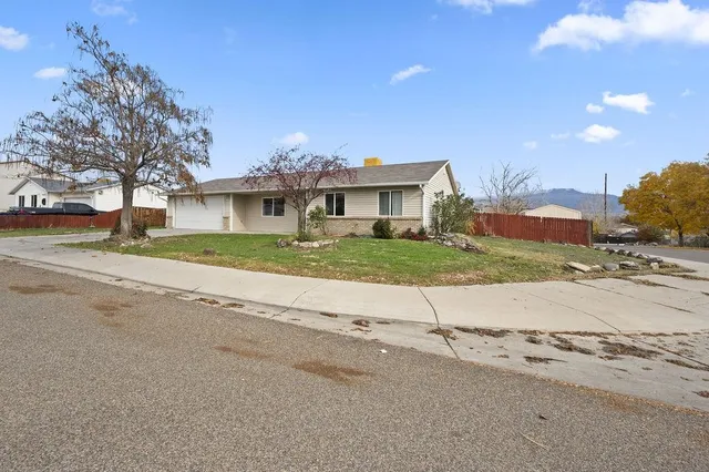 a view of street with a house in the background