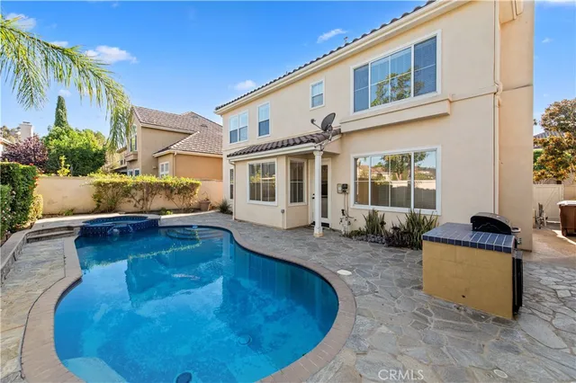 a swimming pool with outdoor seating and yard