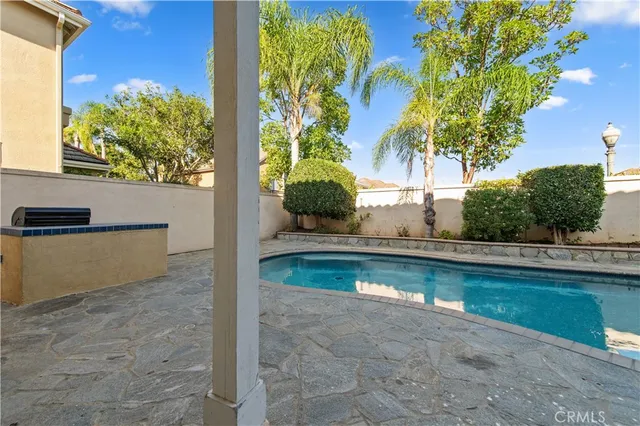 a kitchen with granite countertop white cabinets and stainless steel appliances