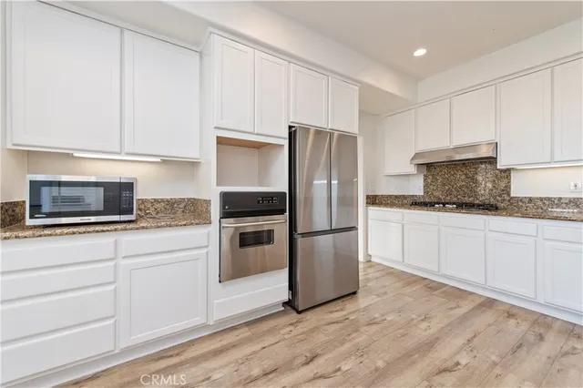 a kitchen with a refrigerator and a window