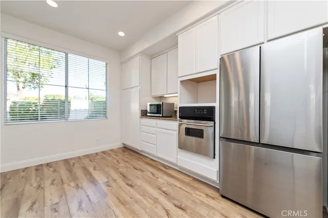 a kitchen with granite countertop a sink stove and cabinets