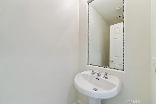 an empty room with windows a fireplace and wooden floor