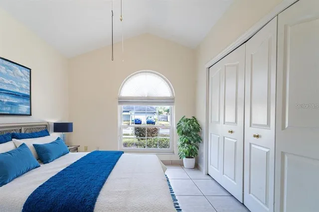 a view of a hallway with wooden floor and a living room