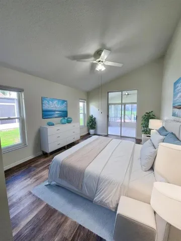 an aerial view of a house with swimming pool and large trees