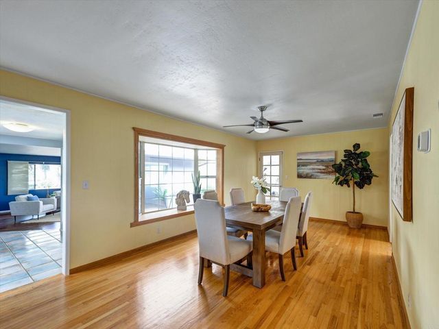 a view of a dining room with furniture and wooden floor