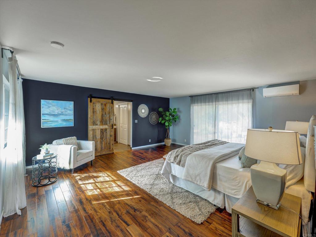 970 Quail Knoll Road Fallbrook, CA 92028 - Photo 17 of 45 a bedroom with a bed and wooden floor