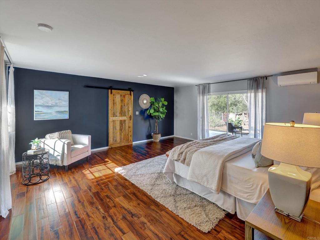 970 Quail Knoll Road Fallbrook, CA 92028 - Photo 18 of 45 a bedroom with a bed and wooden floor