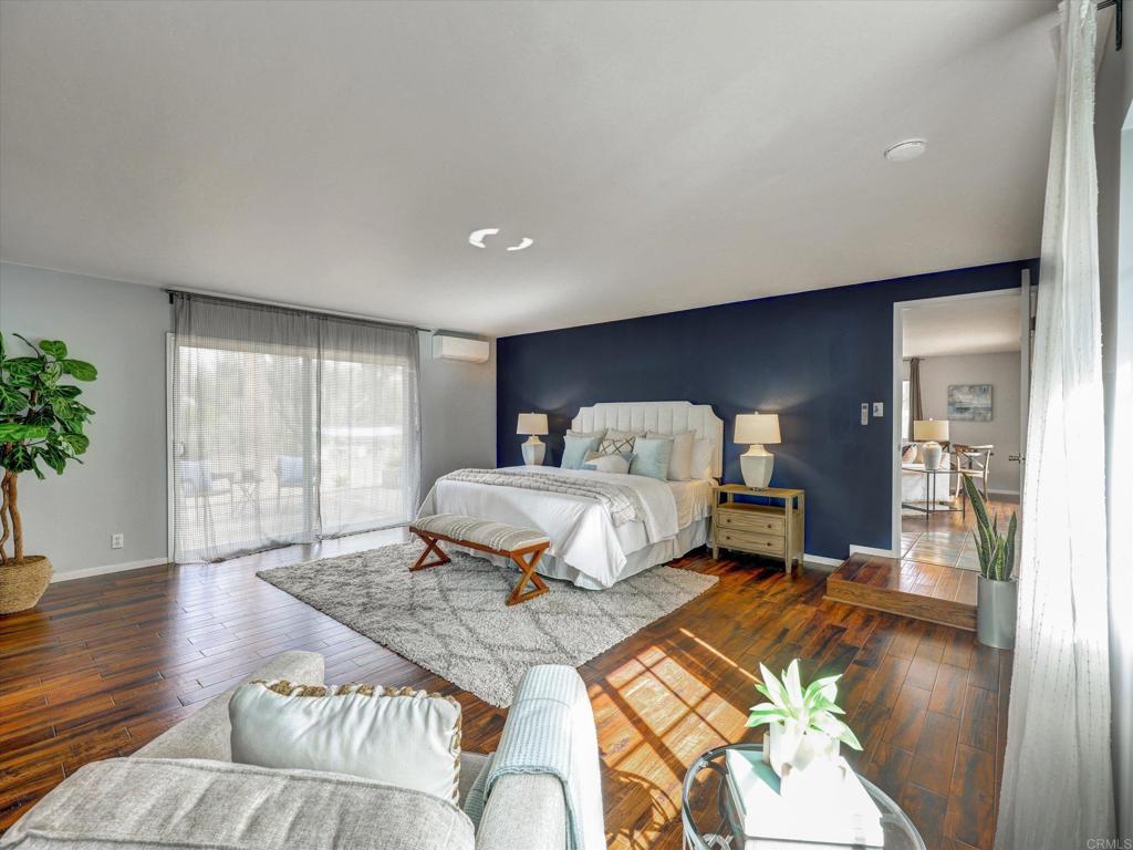 970 Quail Knoll Road Fallbrook, CA 92028 - Photo 19 of 45 a spacious bedroom with a bed and wooden floor