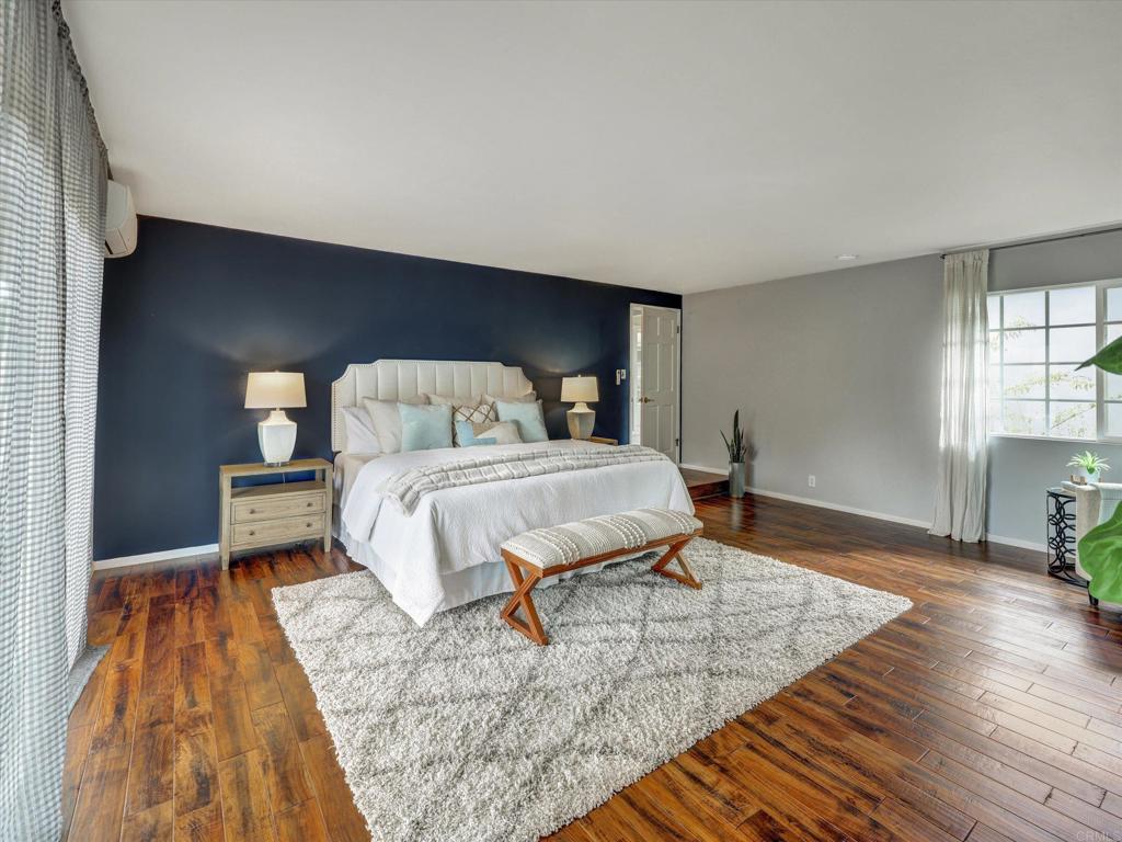 970 Quail Knoll Road Fallbrook, CA 92028 - Photo 20 of 45 a bedroom with a bed and wooden floor