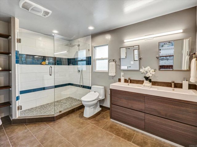 a bathroom with a sink mirror and toilet