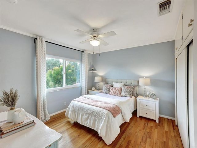 a bedroom with a large bed and a window