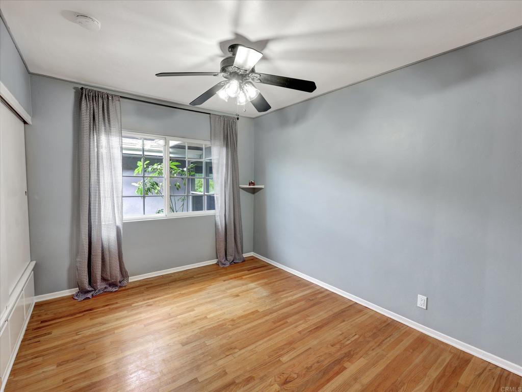 970 Quail Knoll Road Fallbrook, CA 92028 - Photo 31 of 45 an empty room with wooden floor fan and windows