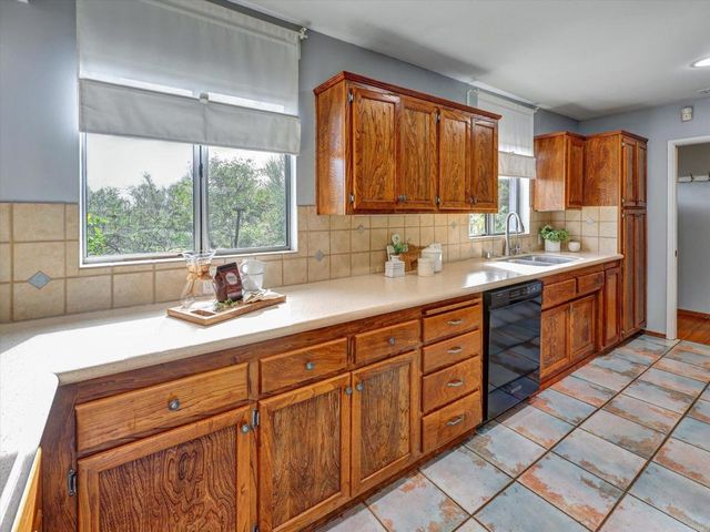 a spacious bathroom with double vanity sink a mirror and a window