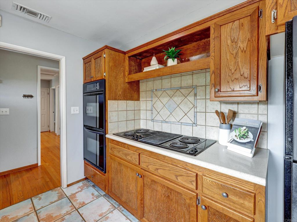 970 Quail Knoll Road Fallbrook, CA 92028 - Photo 5 of 45 a kitchen with stainless steel appliances granite countertop a refrigerator and a stove
