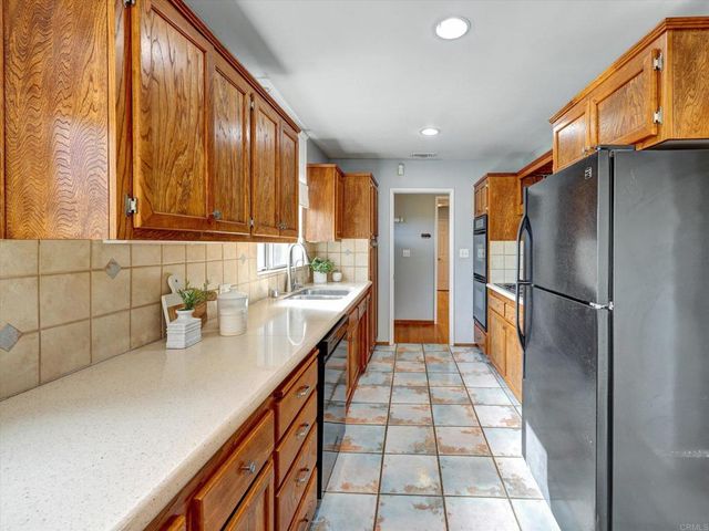 a kitchen with stainless steel appliances a sink and a refrigerator