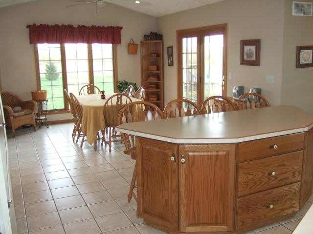 4691 South Farwell Bridge Road German Valley, IL 61039 - Photo 3 of 9 a dining hall with stainless steel appliances granite countertop a sink a dining table and chairs with a large window