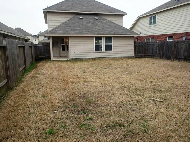 a view of a house with a yard and garage