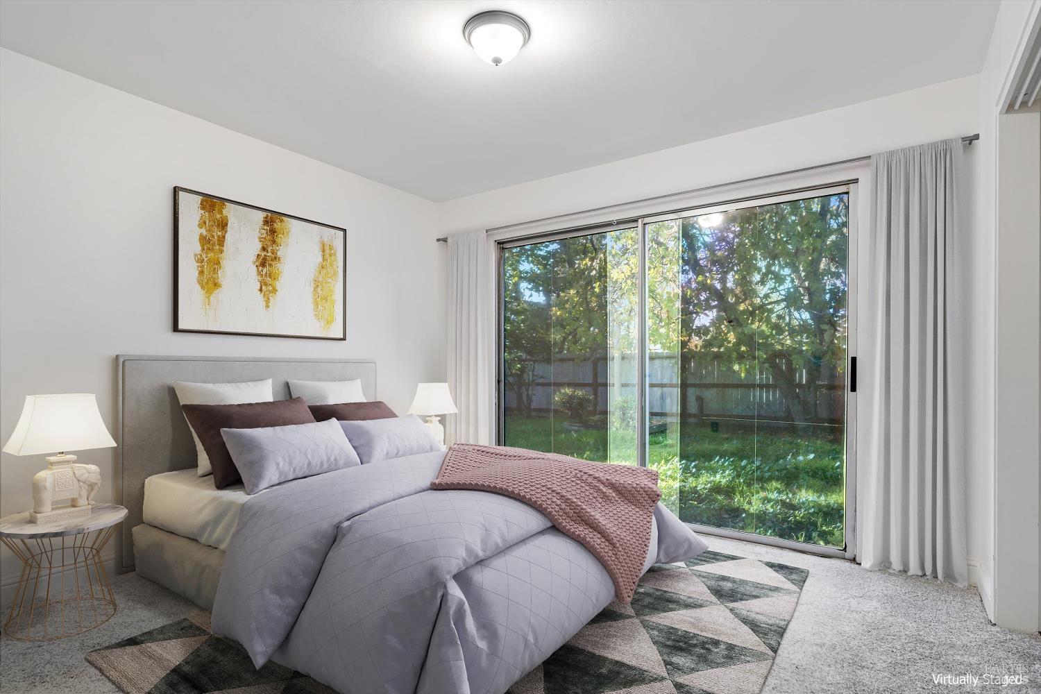 621 Sunny Manor Way Santa Rosa, CA 95401 - Photo 14 of 24 a bedroom with a large bed and a large window