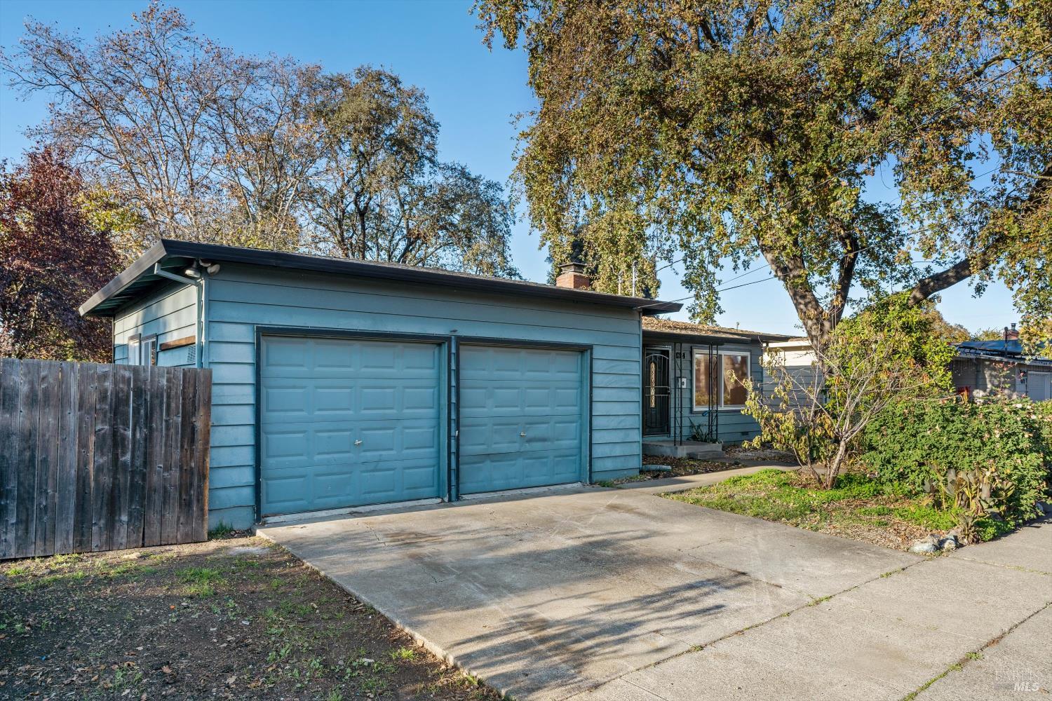 621 Sunny Manor Way Santa Rosa, CA 95401 - Photo 23 of 24 a front view of a house with a yard and garage