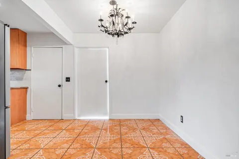 a view of a room with window and chandelier
