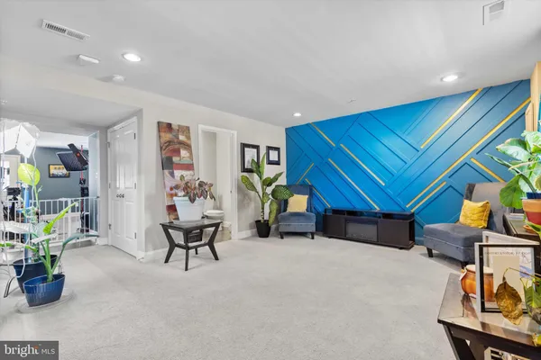 a living room with furniture and gym equipment