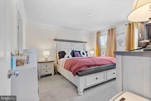 a spacious bedroom with a bed and a chandelier