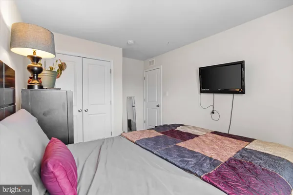 a bedroom with a bed and a flat screen tv