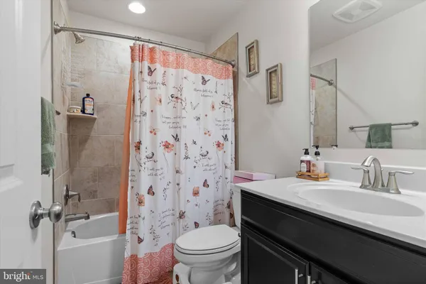 a bathroom with a sink a toilet a shower and a mirror