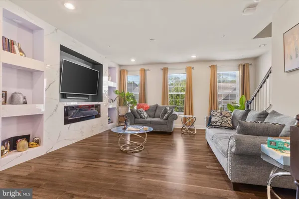a living room with fireplace furniture and a flat screen tv