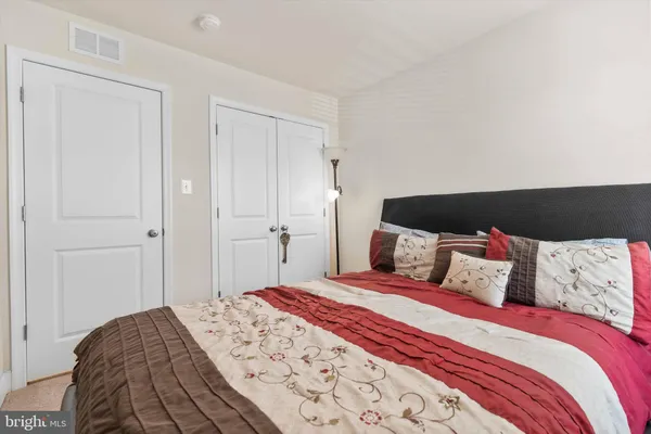 a bedroom with a bed and a closet