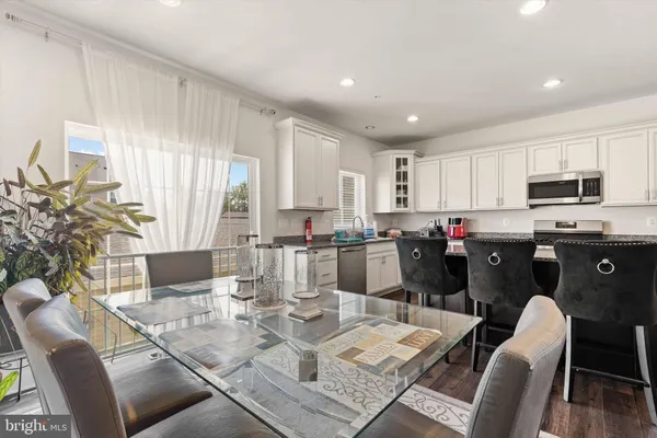 a living room with lots of furniture and kitchen view