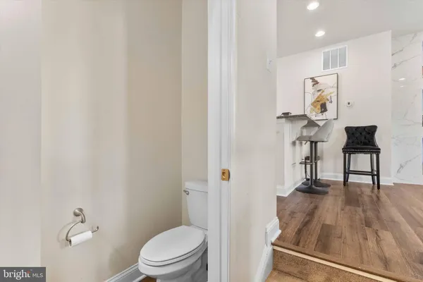 a bathroom with a toilet a sink and mirror
