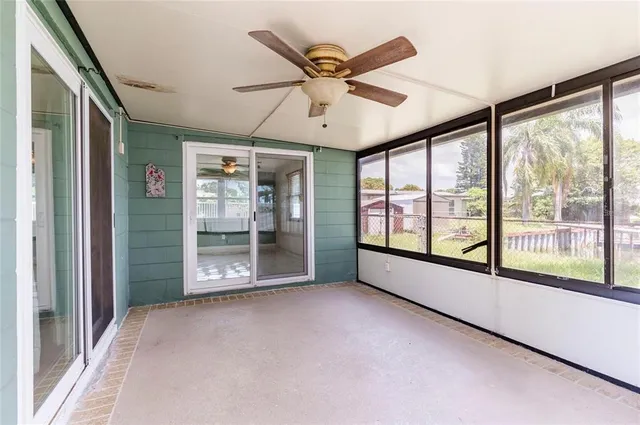 a view of a livingroom with a ceiling fan and window