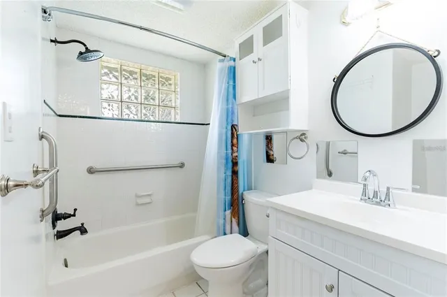 a bathroom with a sink a mirror a toilet and a bathtub
