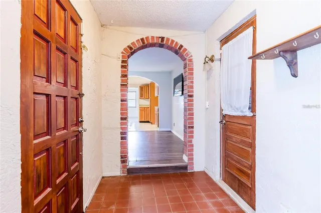 a view of a hallway with wooden floor and entryway