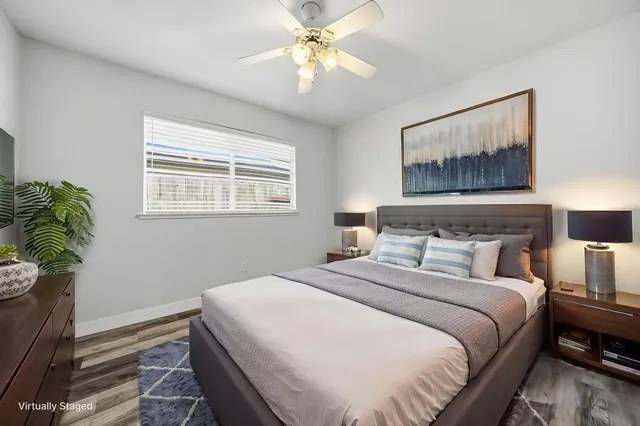 a view of a room with a ceiling fan and a window
