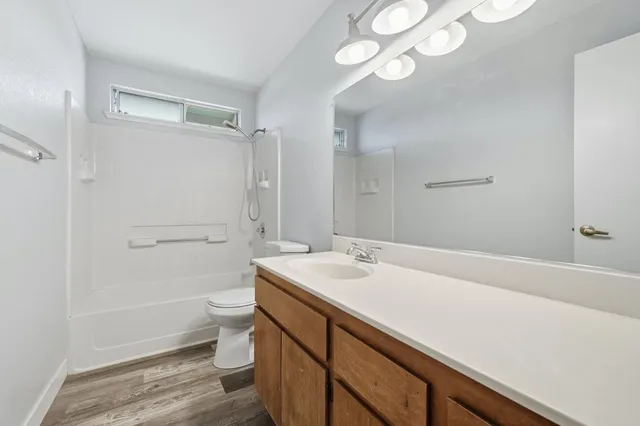 a bedroom with a large bed couch and a window