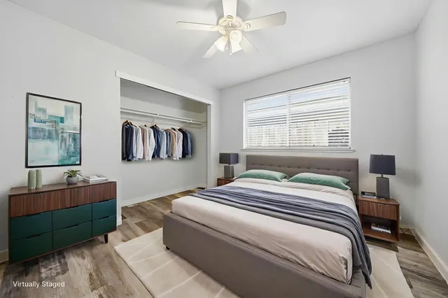 a view of empty room with window and ceiling fan
