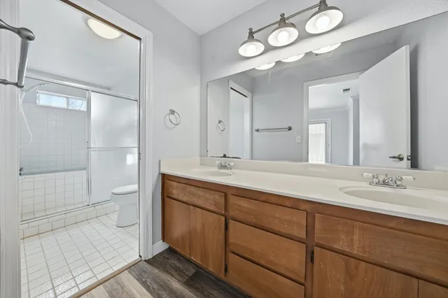 a white toilet sitting next to a bathroom sink