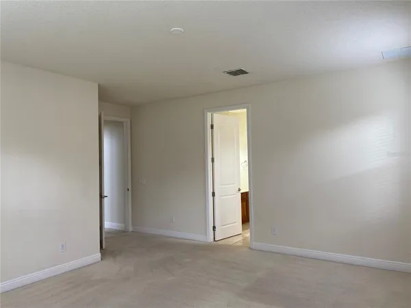 a bathroom with a tub a sink and a large mirror