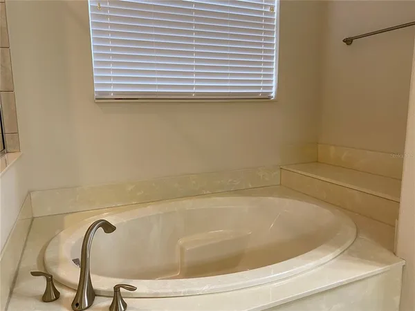 an empty room with furniture and window