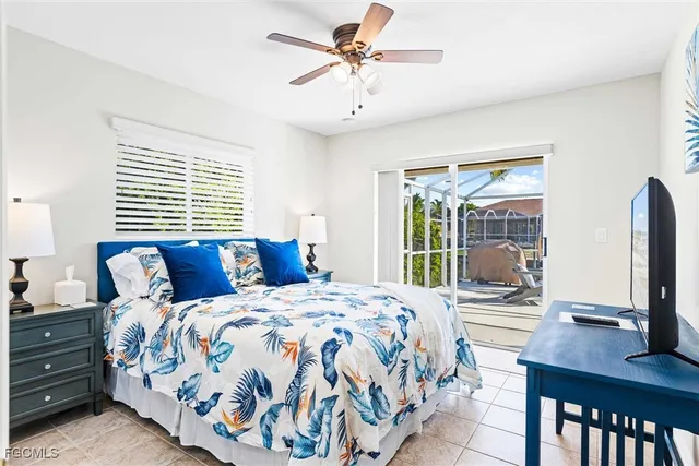 a bedroom with a bed and large windows