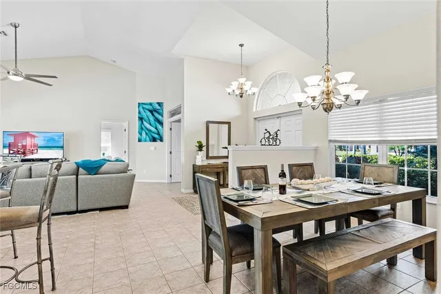 a view of a dining room with furniture a chandelier and window
