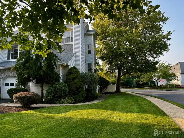 a view of a garden with large trees