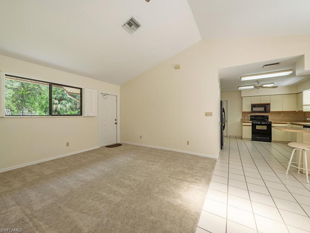177 6th Street Naples, FL 34113 - Photo 3 of 16 a view of a kitchen with furniture and windows