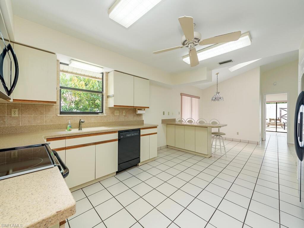 177 6th Street Naples, FL 34113 - Photo 5 of 16 a kitchen with a sink appliances and cabinets