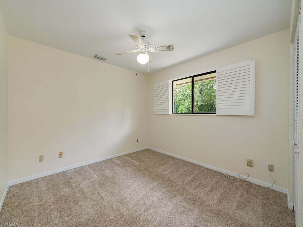 177 6th Street Naples, FL 34113 - Photo 10 of 16 an empty room with a window and a fan
