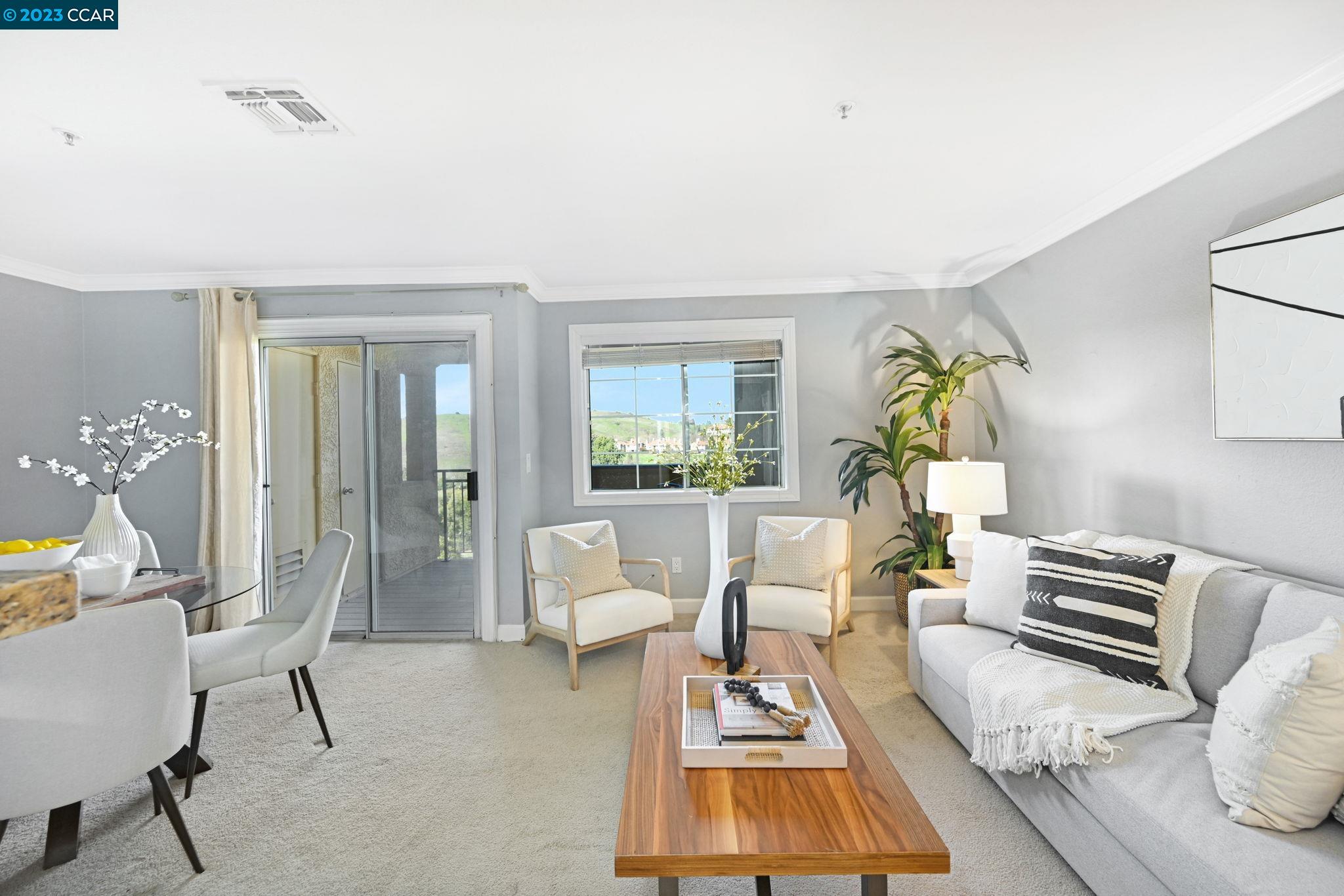 a living room with furniture a rug and a large window